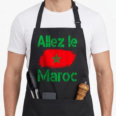 Tablier de cuisine noir avec une touche de peinture rouge portant une étoile verte et le message Allez le Maroc en lettres vertes.