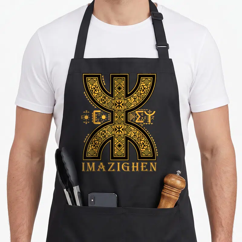 Tablier de cuisine noir avec grand symbole Z imazighen or et inscription tifinagh en bas