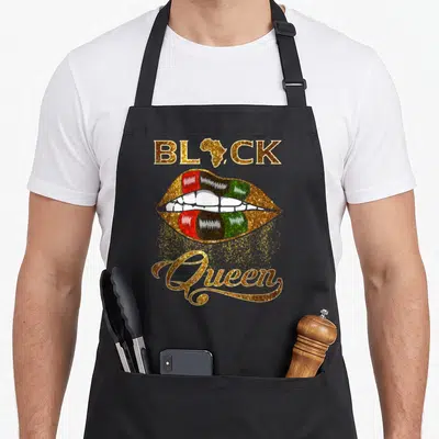 Tablier de cuisine noir avec lèvres multicolores et texte Black Queen en lettres dorées brillantes.