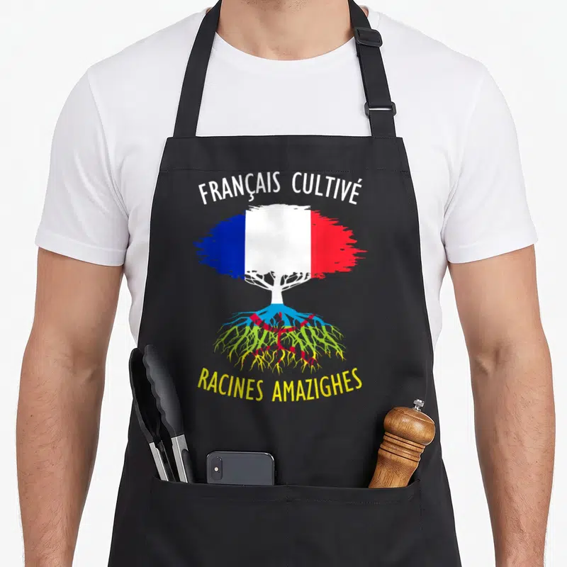 Tablier de cuisine noir avec drapeau français stylisé en arbre aux racines multicolores et texte français cultivé racines amazighes.