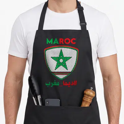 Tablier de cuisine noir avec écusson vert et rouge intégrant une étoile et motif Keffiyeh palestinien.