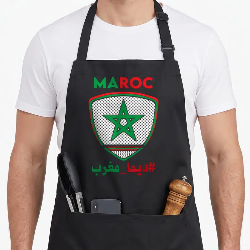 Tablier de cuisine noir avec écusson vert et rouge intégrant une étoile et motif Keffiyeh palestinien.
