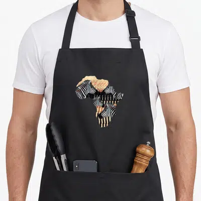 Tablier de cuisine noir avec une carte d'Afrique stylisée composée de têtes de zèbres aux rayures noires et blanches.