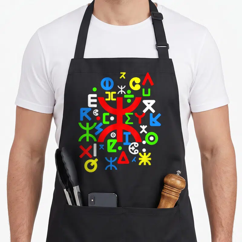 Tablier de cuisine noir avec motifs de la poterie kabyles en couleurs vives et symboles géométriques traditionnels.