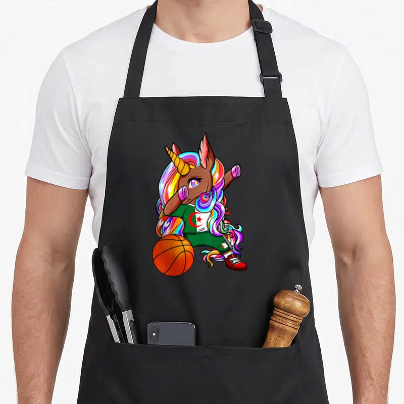 Tablier de cuisine noir avec licorne aux cheveux arc-en-ciel faisant un dab avec un ballon de basket et un maillot vert blanc rouge.