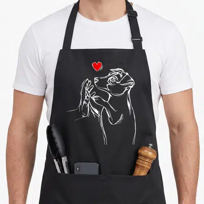 Tablier de cuisine noir avec illustration blanche main et chien Jack Russell Terrier sous un cœur rouge vif.