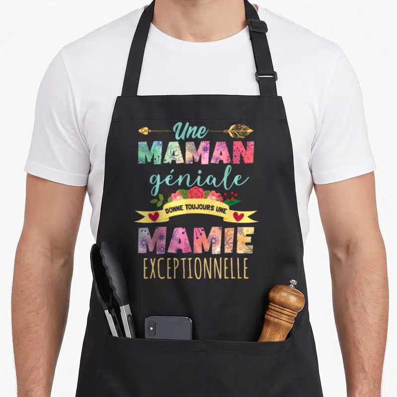 Tablier de cuisine noir avec inscription colorée Une maman géniale donne toujours une mamie exceptionnelle ornée de fleurs et d'une flèche dorée.