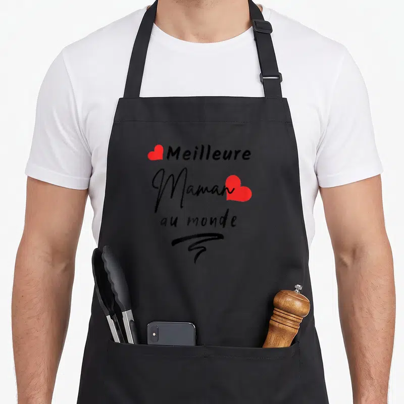 Tablier de cuisine noir avec inscription Meilleure Maman au monde et deux cœurs rouges stylisés.