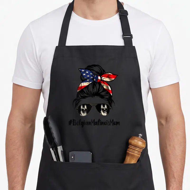 Tablier de cuisine noir avec illustration d'un chignon, d'un bandano aux étoiles et d'une paire de lunettes de soleil reflétant deux chiens.