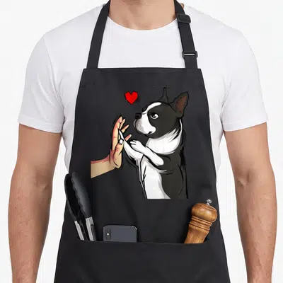 Tablier de cuisine noir avec illustration d'un Boston Terrier touchant une main sous un cœur rouge vif.