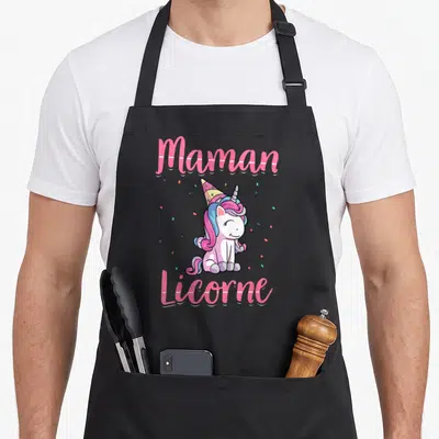 Tablier de cuisine noir avec une licorne rose portant un chapeau de fête et le texte Maman Licorne en lettres roses.