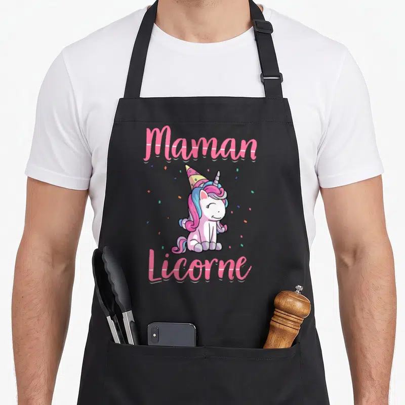 Tablier de cuisine noir avec une licorne rose portant un chapeau de fête et le texte Maman Licorne en lettres roses.