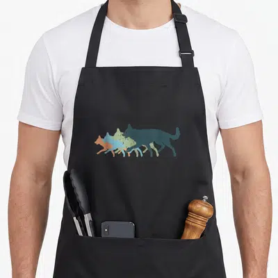 Tablier de cuisine noir avec silhouettes superposées de chiens Berger allemand et Alsacien aux couleurs pastel vintage.