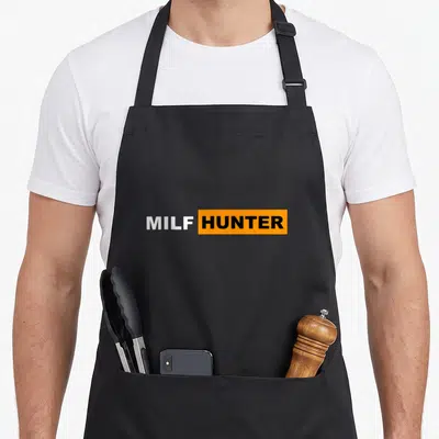 Tablier de cuisine noir avec l'inscription MILF HUNTER en typographie blanche et noire sur bande orange.
