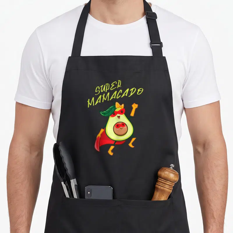 Tablier de cuisine noir avec illustration d'avocat super-héros portant un masque rouge et une cape.