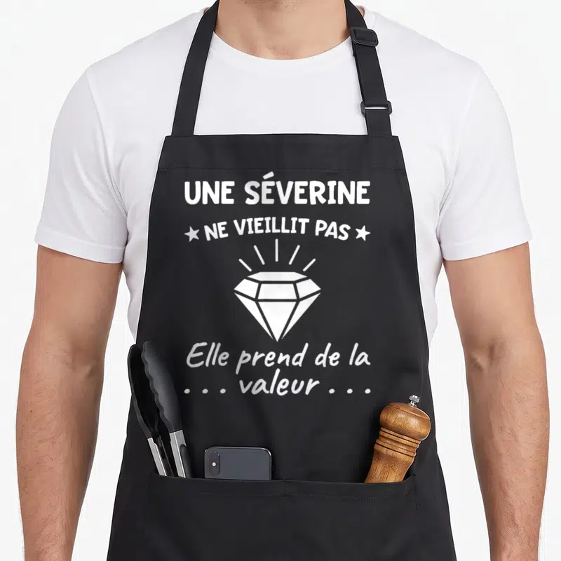 Tablier de cuisine noir avec une illustration de diamant blanc et le texte Une Séverine ne vieillit pas.