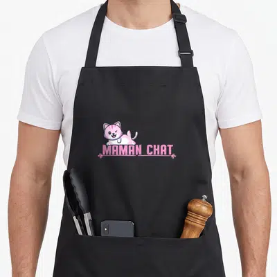 Tablier de cuisine noir avec un chaton rose vif et l'inscription MAMAN CHAT en lettres capitales roses.