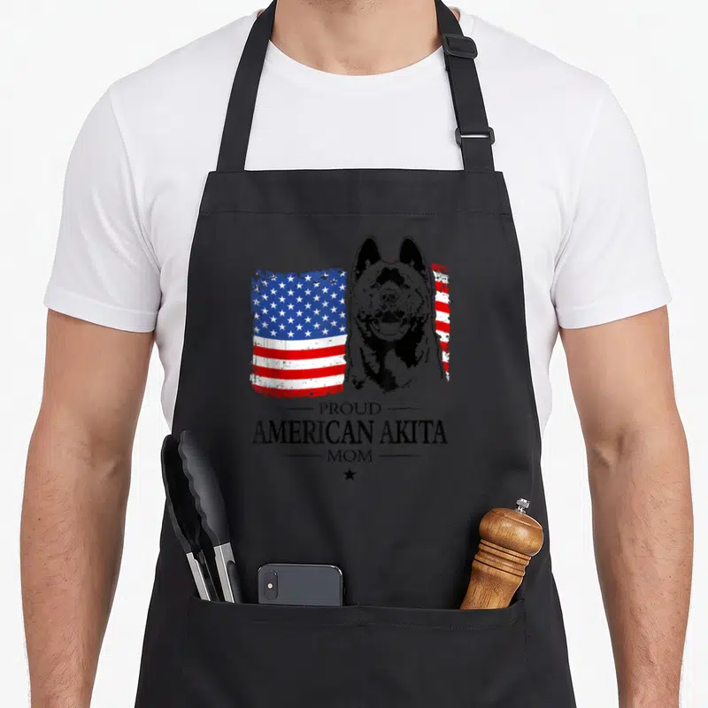 Tablier de cuisine noir avec illustration d'Akita et drapeau américain aux couleurs vives.