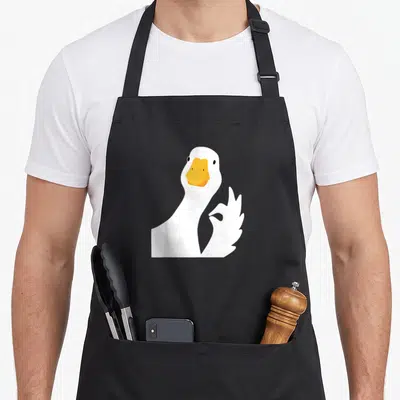 Tablier de cuisine noir avec oie blanche faisant un geste ok orange bec