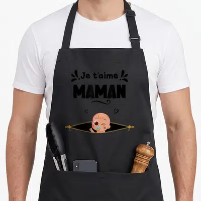 Tablier de cuisine noir avec inscription Je t'aime MAMAN et illustration d'un bébé sortant d'une fermeture éclair dorée.