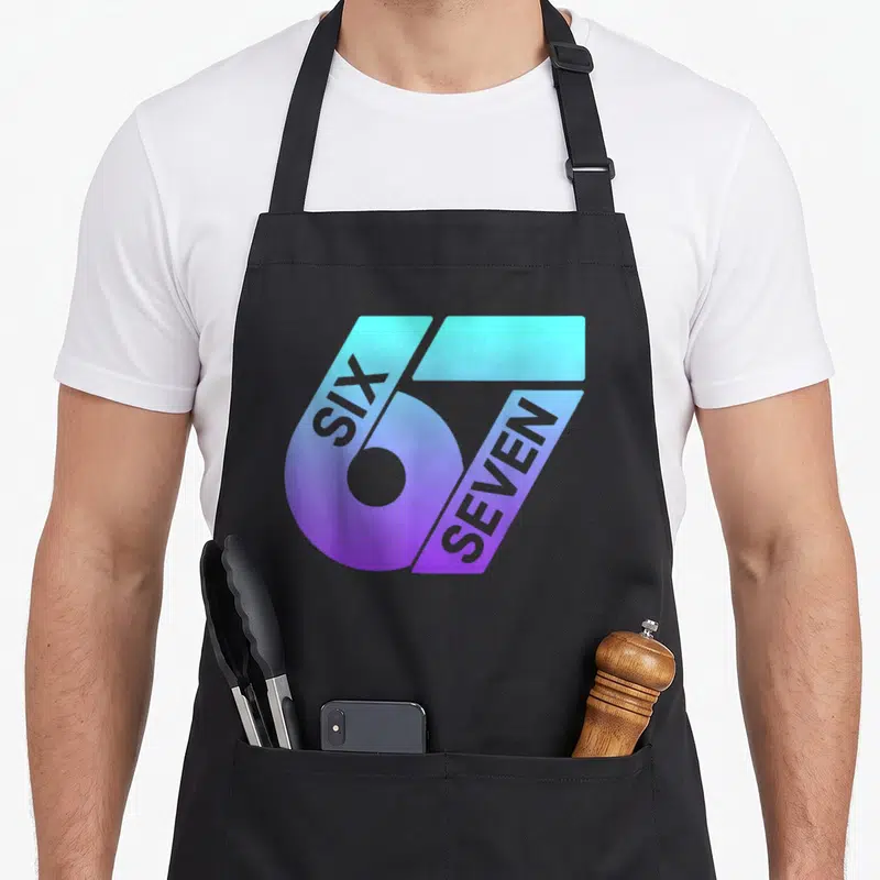 Tablier de cuisine noir avec le logo 67 SIX SEVEN aux couleurs dégradées violet et turquoise.