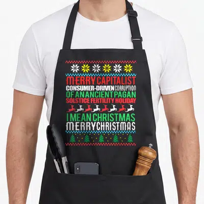 Tablier de cuisine noir avec inscription Merry Capitalist Pagan Vacances Moche Noël et motifs de Noël colorés.