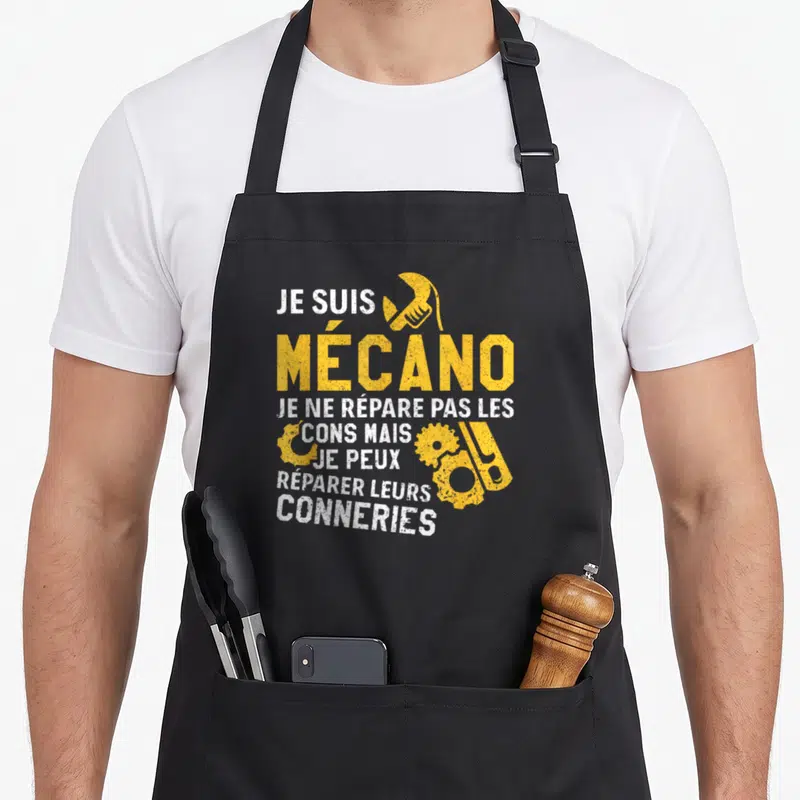 Tablier de cuisine noir avec inscription jaune et blanche sur le thème du métier de mécanicien et d'outils.