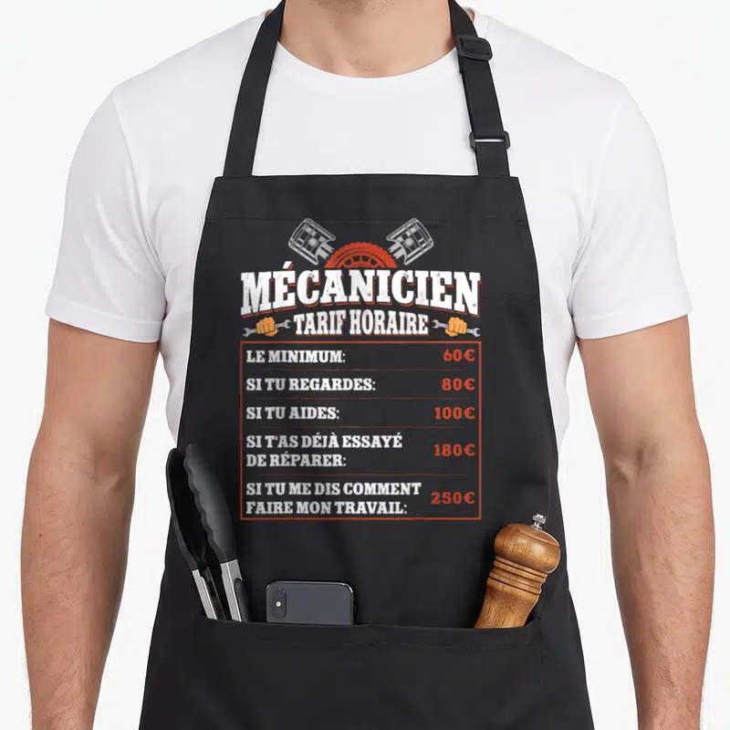 Tablier de cuisine noir avec une liste de tarifs horaires de mécanicien illustrée par des pistons et des clés.
