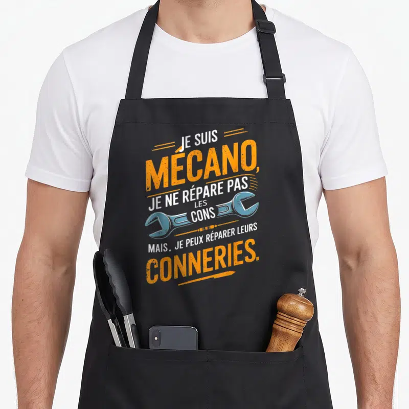 Tablier de cuisine noir avec inscription humoristique orange et illustration de clé à molette bleue sur fond uni.