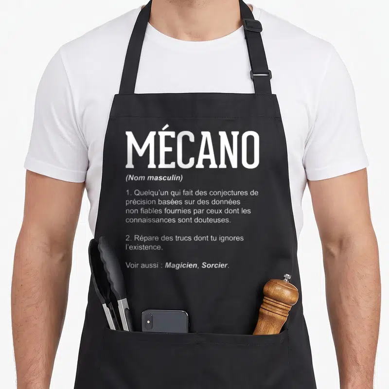 Tablier de cuisine noir avec la définition dictionnaire du mecano en texte blanc centré