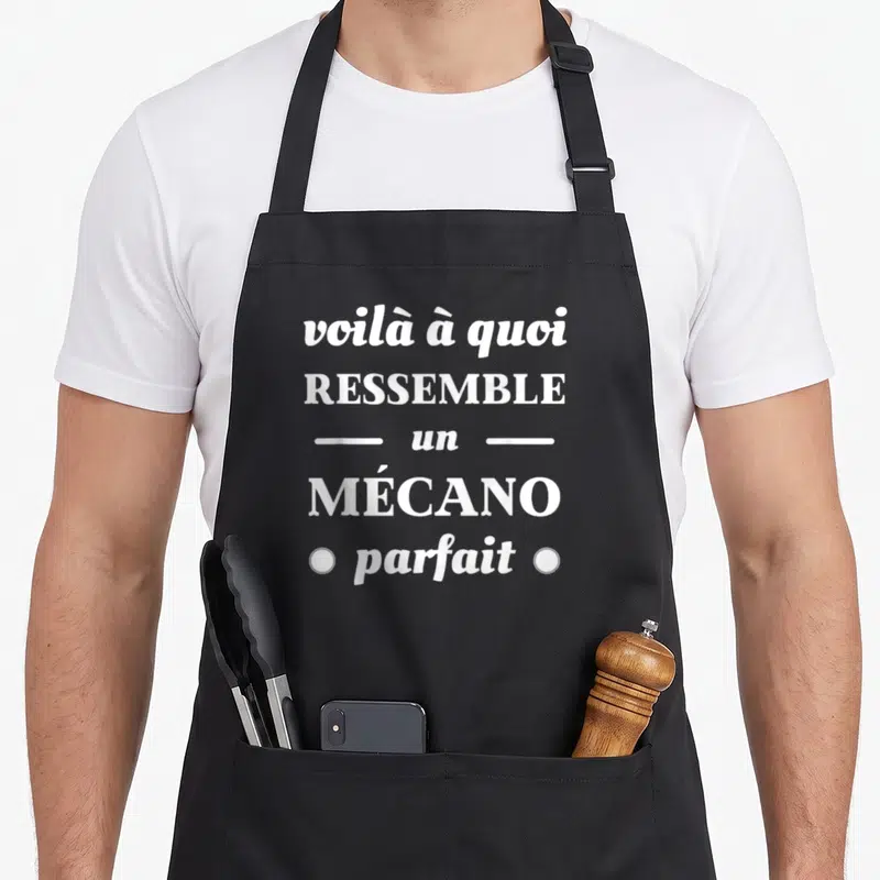 Tablier de cuisine noir avec l'inscription blanche voilà à quoi ressemble un mécano parfait.