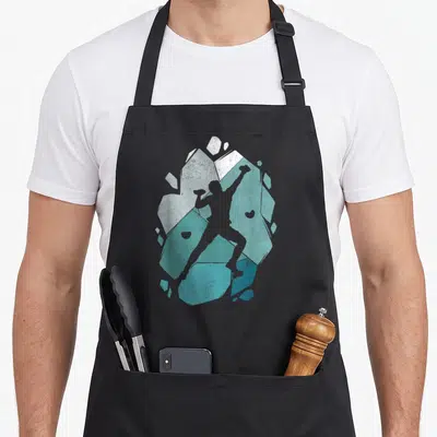 Tablier de cuisine noir avec une illustration stylisée d'un grimpeur boulder sur des formes géométriques turquoise et grises.