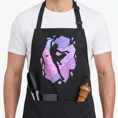 Tablier de cuisine noir avec silhouette de grimpeuse sur fond géométrique rose et bleu pastel texturé.
