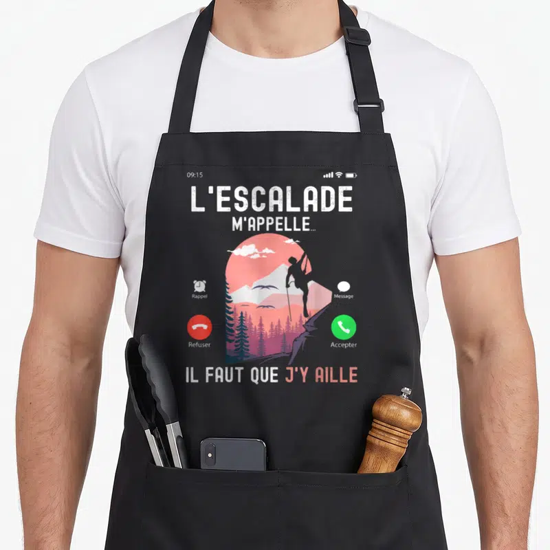 Tablier de cuisine noir avec illustration d'un téléphone affichant un grimpeur et le texte L'escalade m'appelle.
