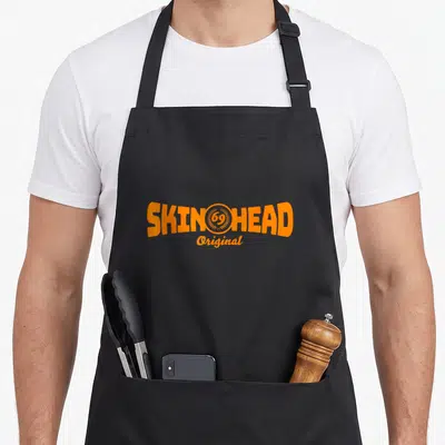 Tablier de cuisine noir avec l'inscription Skinhead Original 69 en orange vif au centre du torse.