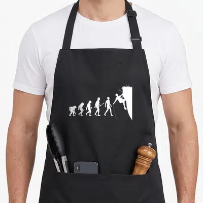 Tablier de cuisine noir avec silhouette blanche représentant l'évolution humaine vers l'escalade sur paroi verticale.