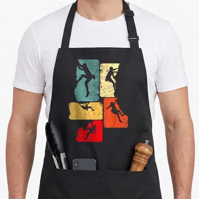 Tablier de cuisine noir avec cinq silhouettes de grimpeurs sur rectangles bleu, jaune et rouge texturés.