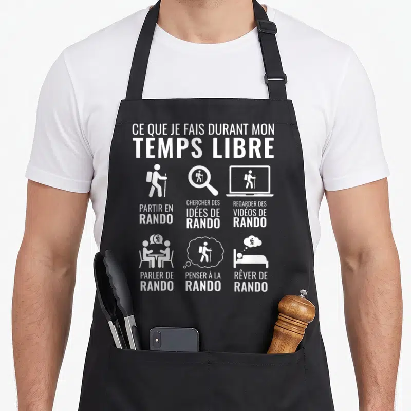 Tablier de cuisine noir avec inscription blanche Ce que je fais durant mon temps libre et six pictogrammes représentant la passion de la randonnée.