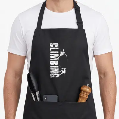 Tablier de cuisine noir avec l'inscription CLIMBING et deux silhouettes de grimpeurs en blanc.