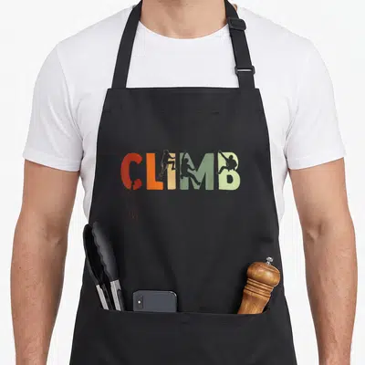 Tablier de cuisine noir avec le mot Clim en lettres colorées et silhouettes de grimpeurs sur chaque caractère.
