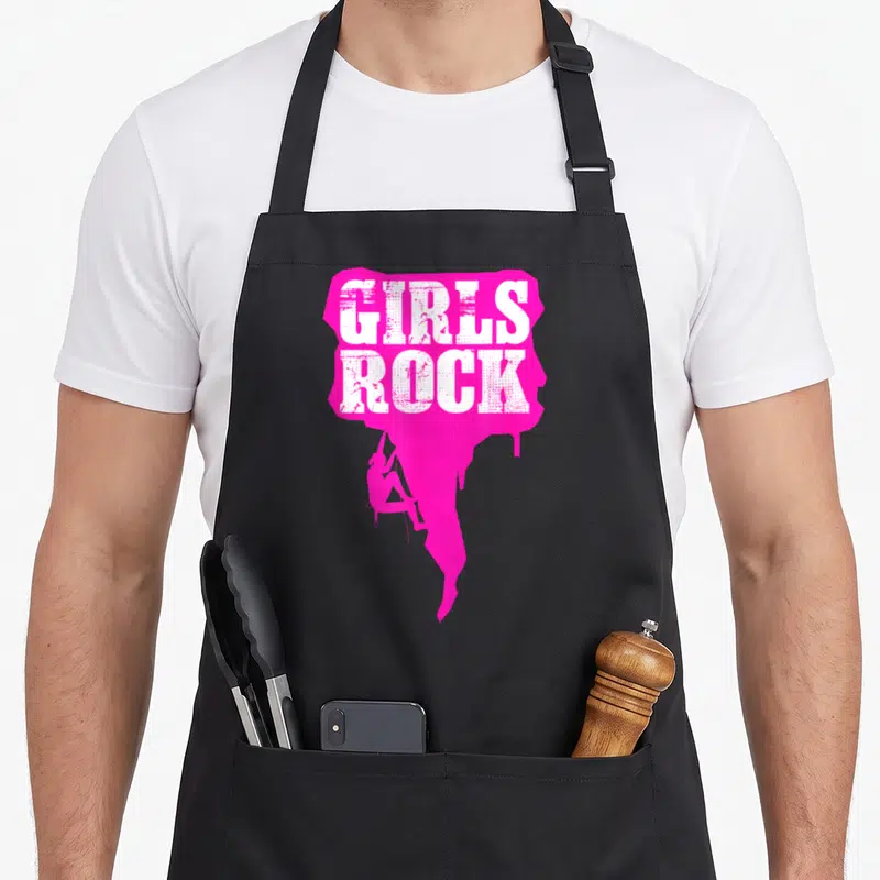Tablier de cuisine noir avec inscription Girls Rock et silhouette d'escaladeuse rose fluo.