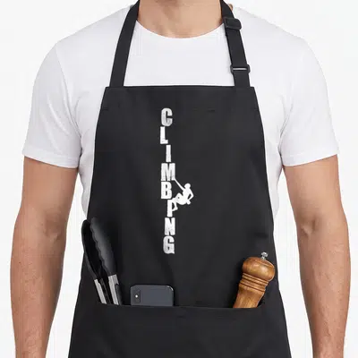 Tablier de cuisine noir avec texte Climbing vertical blanc et silhouette de grimpeur accroché aux lettres.