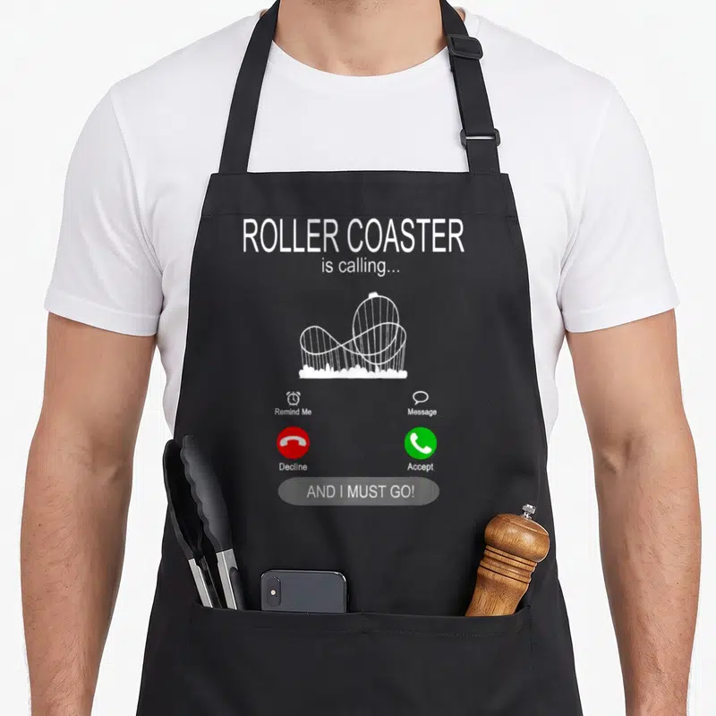 Tablier de cuisine noir avec illustration blanche d'un appel de roller coaster et boutons accepter ou refuser.