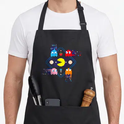 Tablier de cuisine noir avec Pac-Man et fantômes en style glitch pixel art coloré
