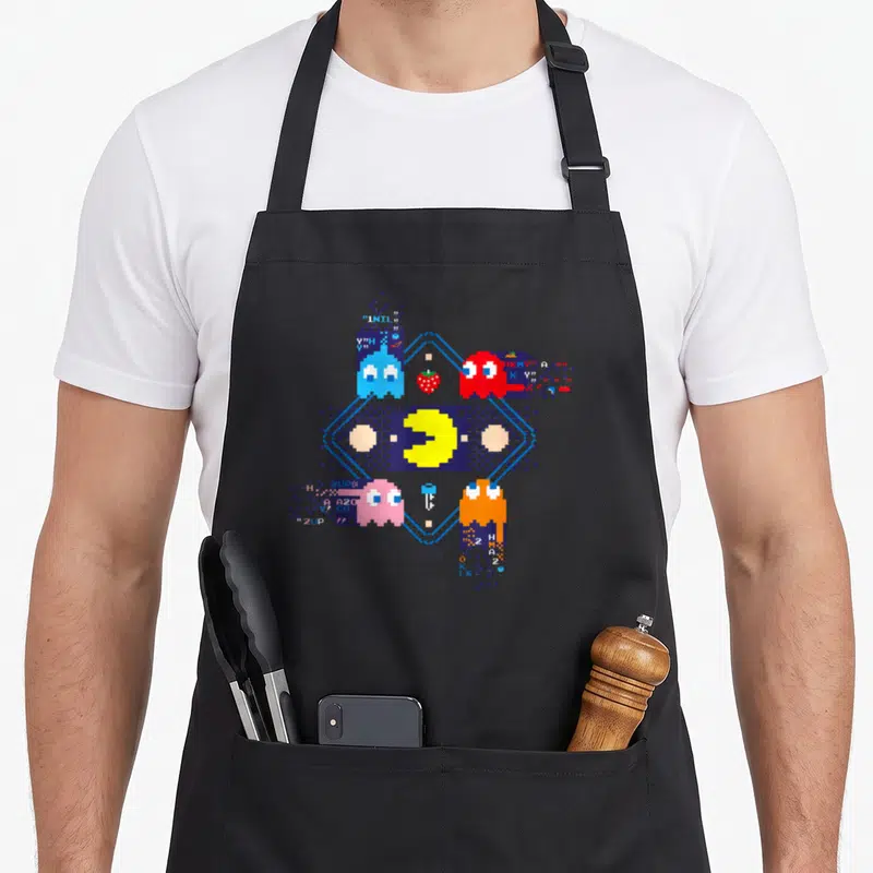 Tablier de cuisine noir avec Pac-Man et fantômes en style glitch pixel art coloré