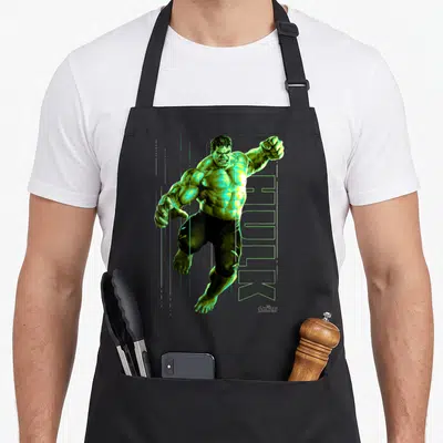 Tablier de cuisine noir avec illustration verte de L'Incroyable Hulk en saut et le mot HULK en lettres stylisées à côté.