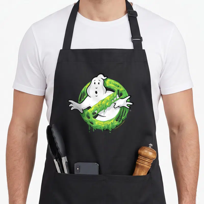 Tablier de cuisine noir avec un ghost blanc traversé par une barre de slime vert fluide.