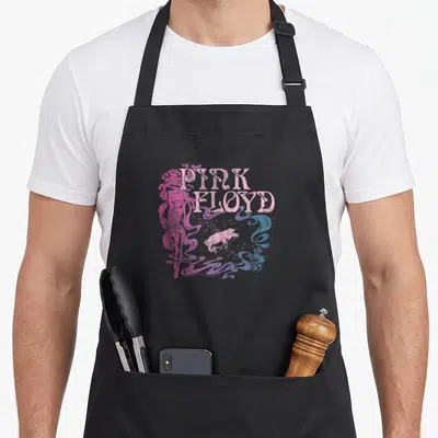 Tablier de cuisine noir avec le logo Pink Floyd, un cochon rose et des nuages violet et bleu.