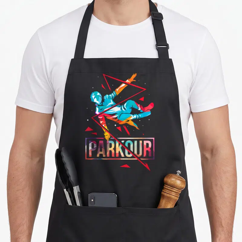 Tablier de cuisine noir avec athlète de parkour sautant, texte PARKOUR et triangles rouges géométriques.