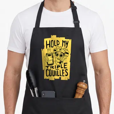 Tablier de cuisine noir avec illustration jaune Hold My Triple Couilles et personnage au chapeau.